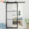 Puerta corrediza de granero de vidrio transparente con marco de acero negro para uso interior
