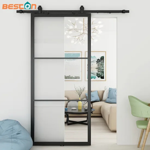 Puerta corrediza de granero de vidrio transparente con marco de acero negro para uso interior