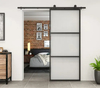 Puerta corrediza de granero de vidrio transparente con marco de acero negro para uso interior