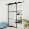 Puerta corrediza de granero de vidrio transparente con marco de acero negro para uso interior